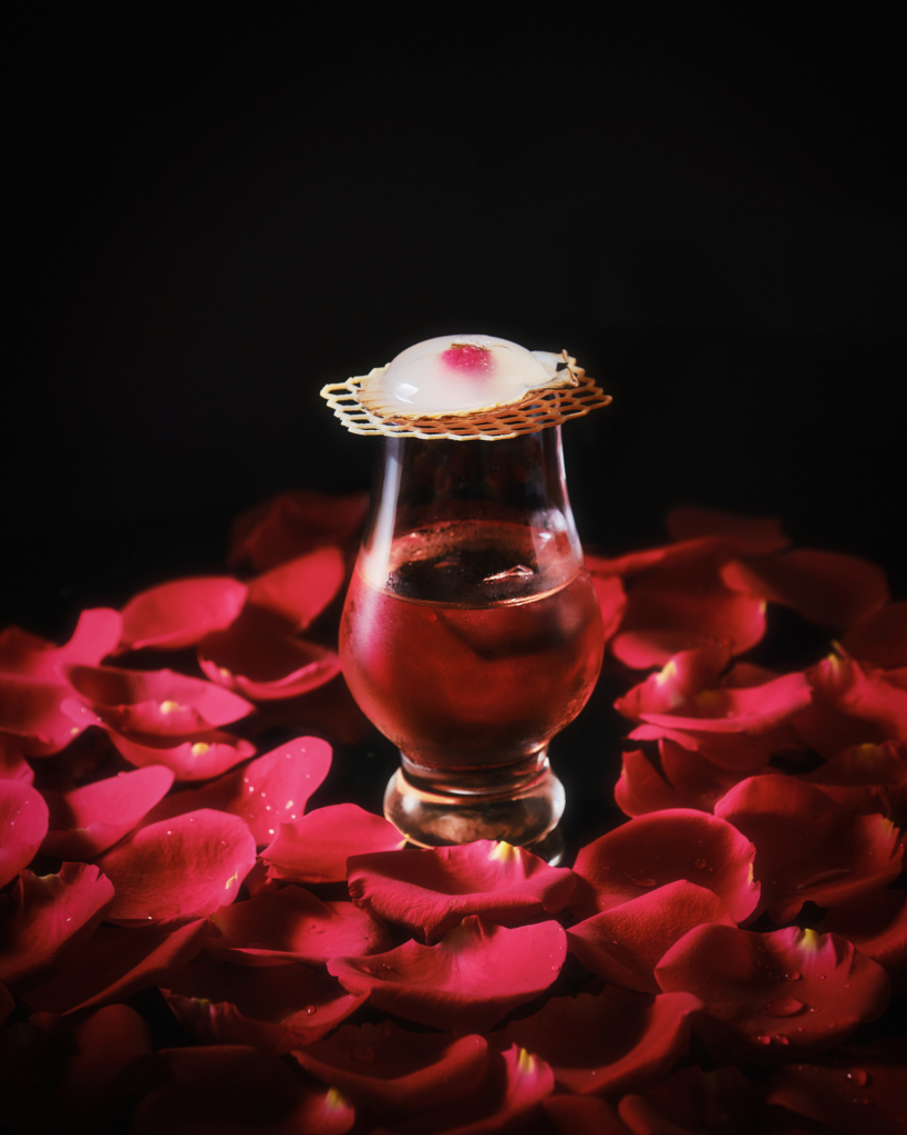 Colorful cocktail in a glass, photographed against a dark background