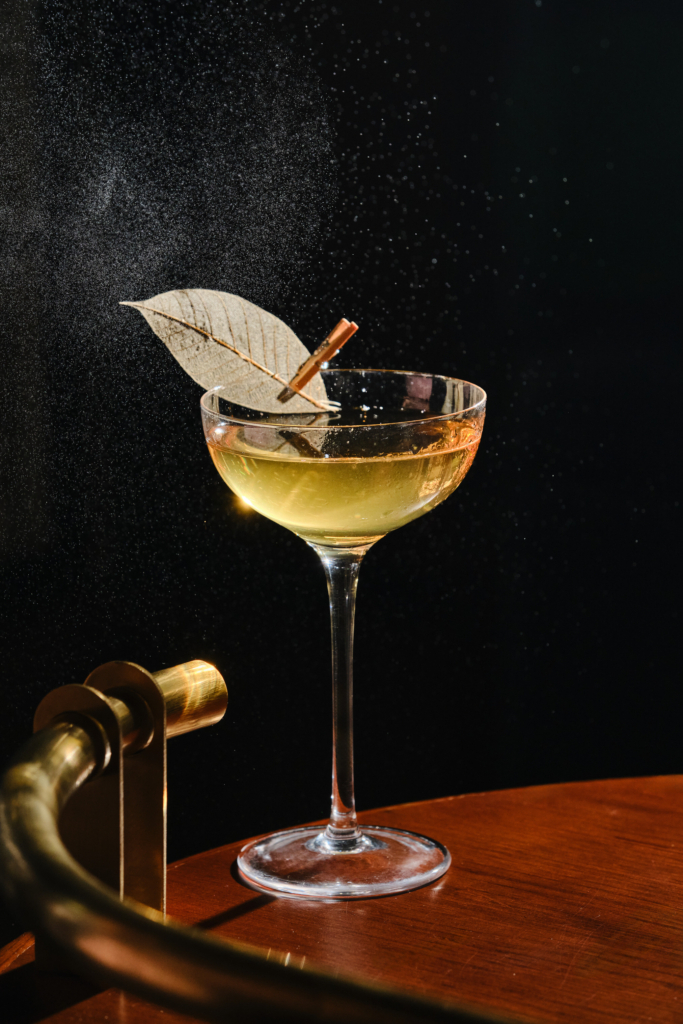 Colorful cocktail in a glass, photographed against a dark background