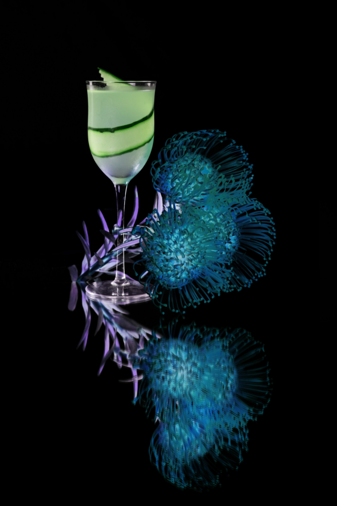 Colorful cocktail in a glass, photographed against a dark background