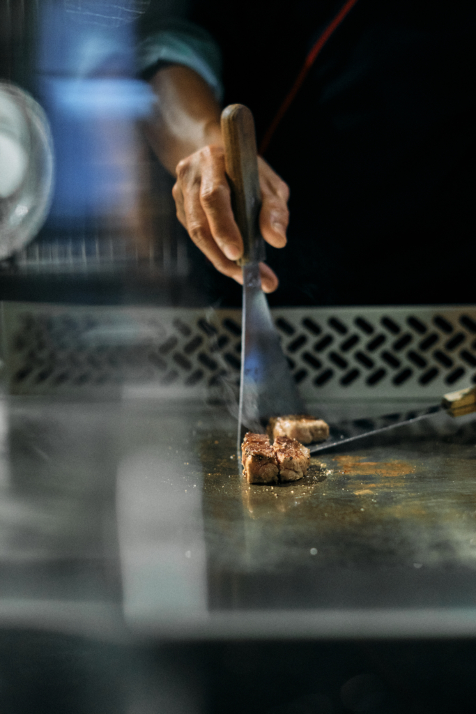 A close-up of food being cooked on a hot grill.