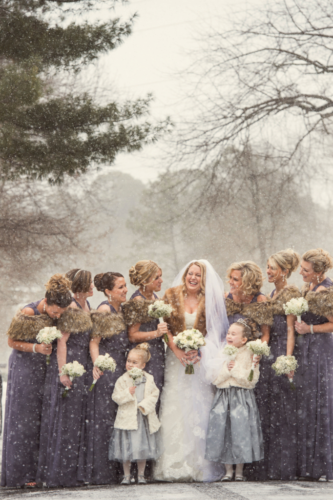 Philadelphia winter weddings are so beautiful. There is something so special about the gorgeous architecture of Philadelphia under a blanket of white snow. At this Philly winter wedding, the bride got ready with her bridesmaids at her parents’ house in the suburbs before heading to the church for her wedding ceremony. When it’s raining or snowing outside, I always ask my clients if they’re comfortable going outdoors for portraits. I don’t ever want brides or grooms to go out in inclement weather if they’re not okay with it! This bride was totally willing to endure the snow for a few beautiful portraits, so we stepped into the street with her bridesmaids for a few quick images. I am so grateful and thankful to her and those ladies for braving that snow! What started out as a few simple flurries rapidly turned into a snowstorm, but they were willing to go out anyhow. If it’s snowing on your wedding day, and you want to go outside, let’s do it! If you’re not comfortable with being out in the wet snow, don’t worry about it. We can still make beautiful images indoors! The most important thing to me is your comfort, and I never want you to do anything that you don’t want to just for a few portraits!