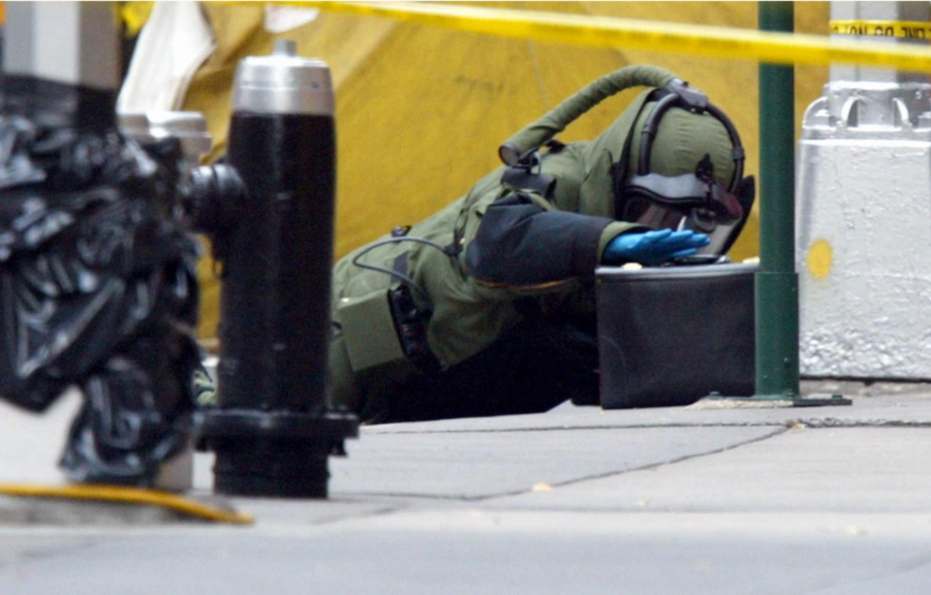 An NYPD Bomb Squad Technician check a suspicious bag in Midtown Manhattan