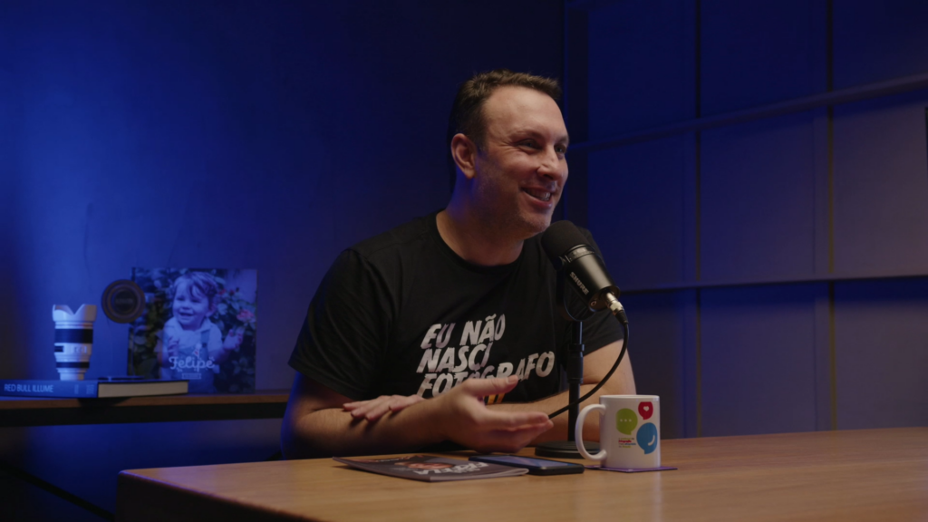 Podcast- A conversation takes place in a studio setting, with people seated and speaking into microphones or engaging in an interview.