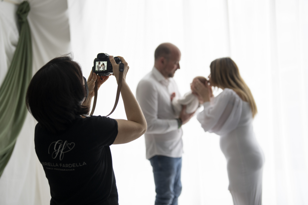 Gabriella Fardella - wife of David  Photographer capturing tender family moments in a softly lit studio setting.