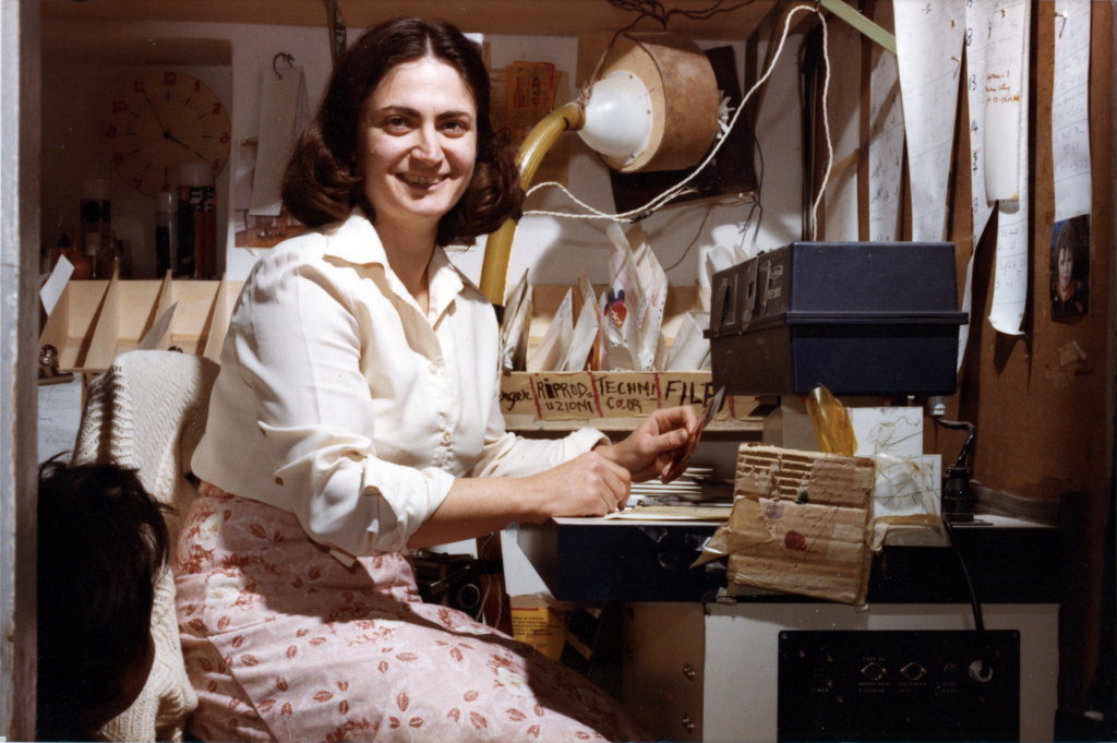 David’s mother working in the family darkroom, handling photographic prints and materials.
