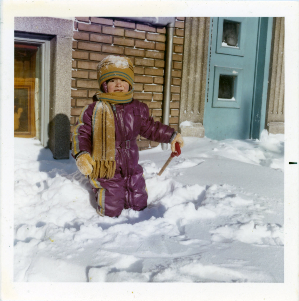 Photographer David as a child in Canada, playing in the snow outside his home.