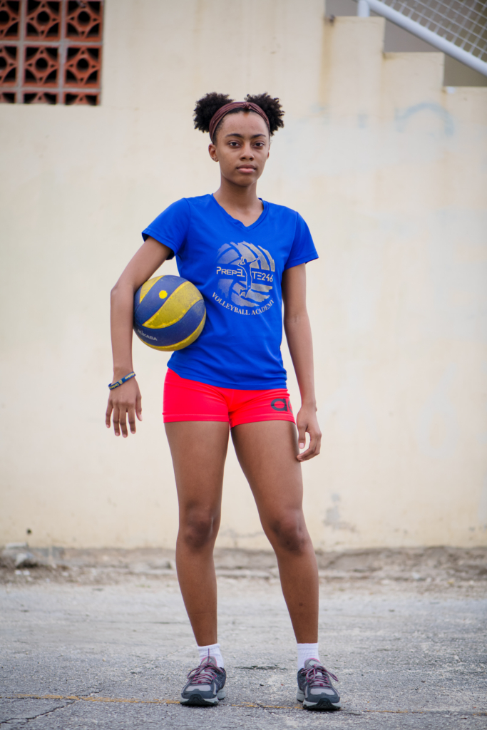 Portrait of a teenage volleyball player holding a ball during the Girls in Sport documentary photography project in Barbados.
