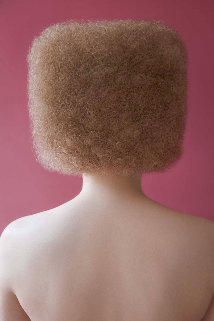 Minimal portrait with geometric afro silhouette and soft pastel color palette.