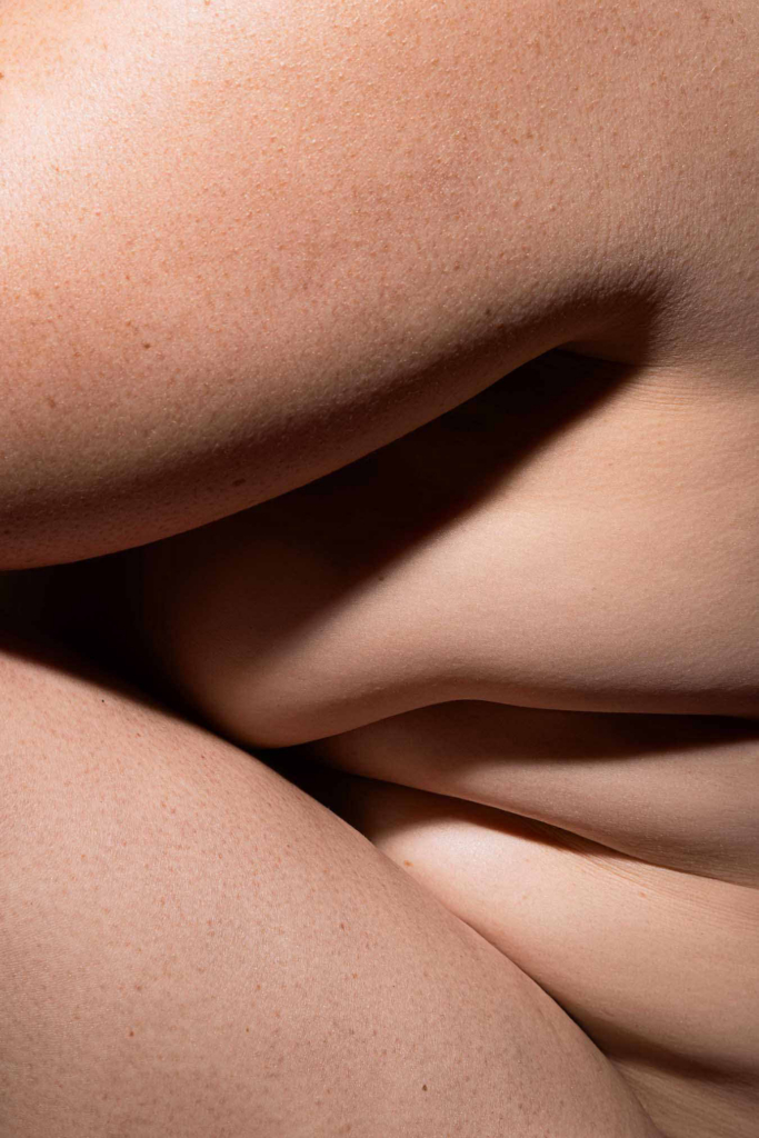 Abstract composition of intertwined body forms with soft natural texture and shadow.