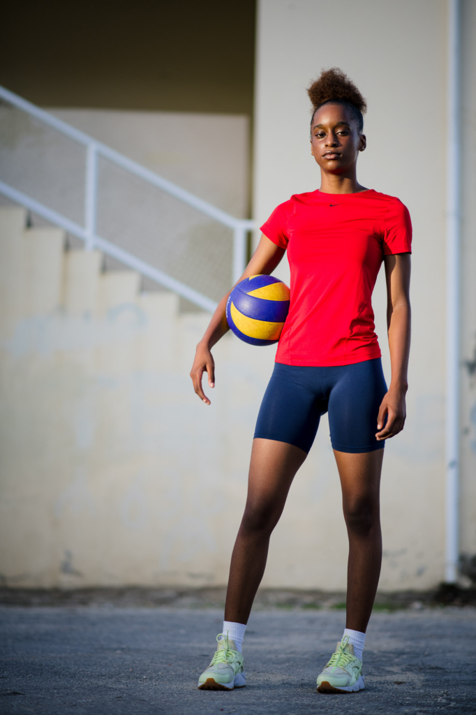 Portrait of a teenage volleyball player holding a ball during the Girls in Sport photography project in Barbados.